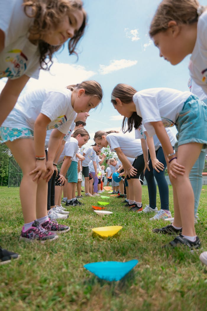 A group of children enjoying outdoor activities in a sunny park setting.